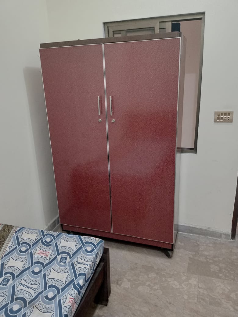 Furnished Room with Student Wardrobe and Bed at The Second Home Boys Hostel Lahore
